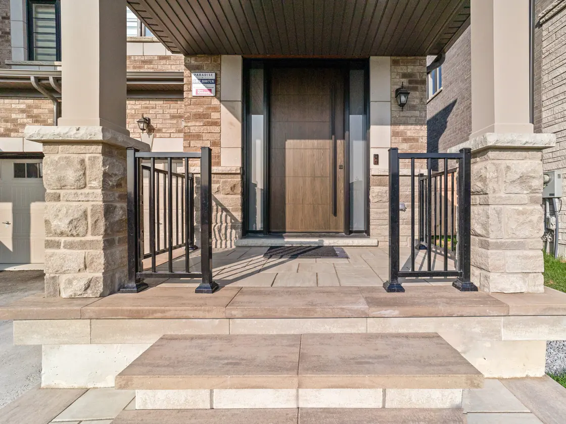 Black aluminum picket guards at a front entry