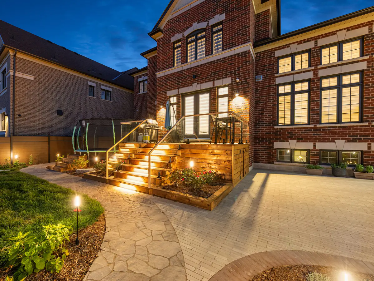 Backyard deck stairs with lighting and handrails at night