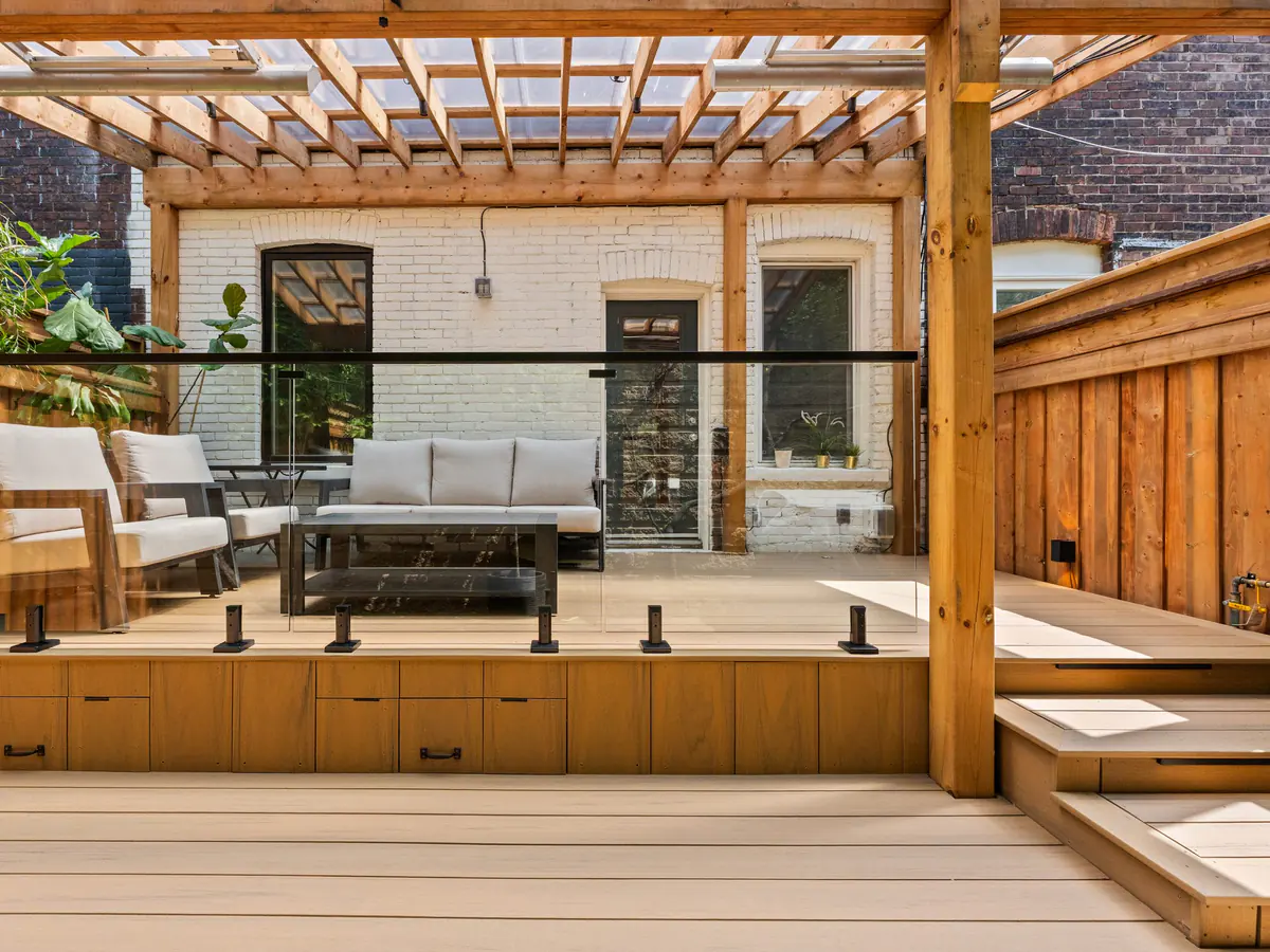 Frameless glass on a cedar deck under a pergola